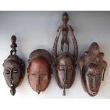 Four African Ivory Coast masks, including Baule and Guro examples, (4) the largest mask measures