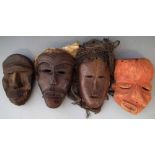 Four African masks including a Pende sickness mask, (4) the largest measures 28cm high       All