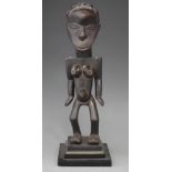 Congolese female figure, with angular shoulders and conical features, 25cm high     All lots in this