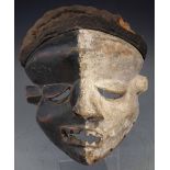 Pende Mbangu sickness mask, with fabric head dress, 31cm high       All lots in this Tribal and