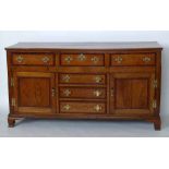 Oak dresser base banded in mahogany of six short drawers and two doors, length 178cm. Condition