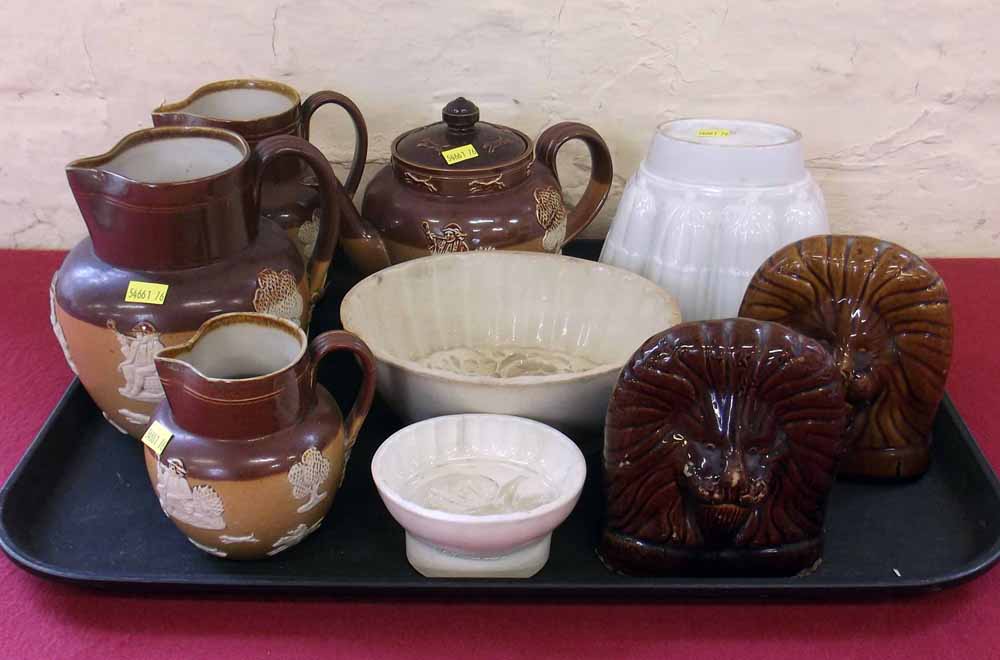Graduated set of Doulton stoneware jugs, a teapot, also a pair of Lion window stops and three