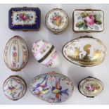Nine Limoges porcelain boxes, including five egg shaped boxes, painted with floral patterns and