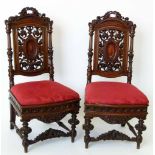 Pair of Henri IV style mahogany heavily carved hall chairs.