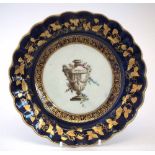 Worcester plate circa 1780, painted with a classical urn within gilt and navy blue border,