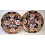 Pair of Chamberlains Worcester armorial plates circa 1800, each painted with a central crest