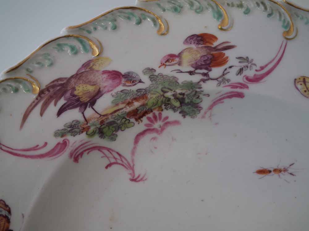 Two Chelsea plates circa 1760, painted with exotic birds within a feather and floral moulded border, - Image 7 of 9