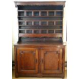 Fruitwood and chestnut dresser, the boarded rack over two panelled doors, width 138cm.