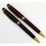 Montblanc Germany black resin ballpoint pen and a similar W-Germany maroon pen (2).