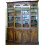 William IV mahogany breakfront bookcase of four glazed doors over four cupboard doors, width