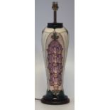 Moorcroft lamp base, decorated with fox gloves, mounted on wood base, the ceramic part measures