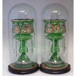 Pair of Victorian green glass lustres, each with fourteen cut glass droppers, under domes, the