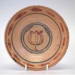 St Ives studio pottery dish attributed to Bernard Leach, painted with a flower head motif, impressed