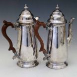 Pair of silver early Georgian style coffee and milk jugs, Birmingham 1947, with composition handles,