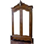 French walnut veneered armoire of two doors with bevelled plates, on leaf carved feet,m width 140cm.