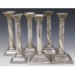 Three pairs of filled silver Corinthian column candlesticks, two pairs with florally entwined stems,