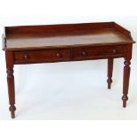 Mahogany washstand, circa 1840, the three-quarter gallery over two apron drawers on reeded legs,