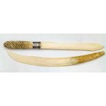 Burmese ivory paginator, the handle carved with a dancer entwined in foliage, length 37cm; also