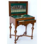 William & Mary style walnut canteen table, the hinged top and apron drawer containing a suite of