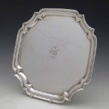 Square silver salver, Jos Gloster, Birmingham 1926, monogrammed, on four bun feet (two missing),