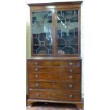 Mahogany secretaire bookcase of two astragal doors over a fall front drawer revealing a fitted