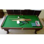 Riley quarter size snooker table with a dining table top, together with cues and balls.