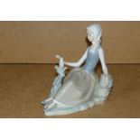 A Lladro Figure of a seated girl with do