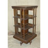 A 19th Century Oak Square Revolving Bookcase having part splat sides, square base with china