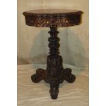 A Burmese Hardwood Round Scalloped Tilt Top Occasional Table having carved and pierced frieze with
