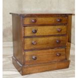 A Miniature Apprentice Straight Front Chest of Drawers having 4 long graduated drawers with wood