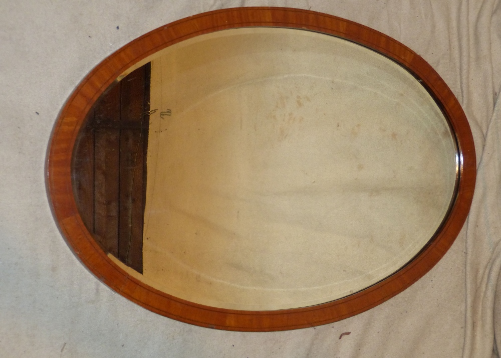 An Edwardian Mahogany Oval Hanging Bevelled Wall Mirror with inlaid boxing and stringing, 89.5cm