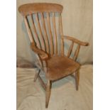 A 19th Century Windsor Armchair having slat back, solid seat on round turned legs