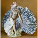 A Lladro Figure of a young lady with a peacock, 28.5cm high