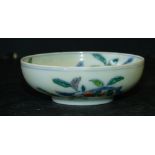 An Oriental Small Round Dish on white ground with multicoloured floral, fruit and leaf decoration,
