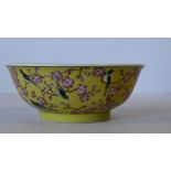 An Oriental Small Round Shallow Bowl on yellow ground having multicoloured bird and blossom