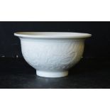 An Oriental White China Trumpet Shaped Bowl having raised dragon and phoenix decoration, 15cm