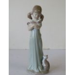 A Lladro Figure of a young girl holding a kitten with a cat at her feet, 21cm high