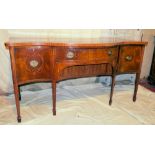 A 19th Century Mahogany Serpentine Fronted Sideboard having all over vase floral, shell, ribbon,