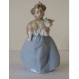 A Lladro Figure of a young girl holding a cat, 19.5cm high