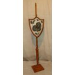 A 19th Century Satinwood Pole Screen having shield shaped woolwork screen with painted leaf and