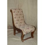 A Carved Oak Slipper Chair having floral overstuffed seat, carved sides with raised floral and leaf