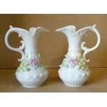 A Pair of Belleek Bulbous Thin Necked Jugs having encrusted floral decoration, 19cm high