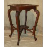 An Oak Square Occasional Table having chamfer corners, carved centre panels, with floral and scroll