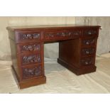 A 19th Century Oak Kneehole Double Pedestal Desk having inset top, centre drawer flanked by 8 short