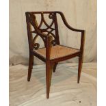 An Edwardian Mahogany Armchair having inlaid banding and stringing, pierced scroll back, bergere
