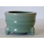 An Oriental Green Glazed Earthenware Small Round Pot on 3 splayed feet, 9.5cm diameter