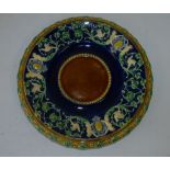 A Minton Majolica  Round Plate on brown, blue and green ground having raised figure, bird, floral