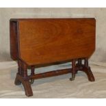 A Victorian Mahogany Sutherland Table having chamfer corners, on round turned legs with castors,