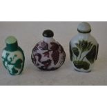 3 Peking Glass Style Snuff Bottles on white purple and green ground