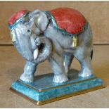 A Halcyon Days China figure of an elephant on rectangular shape base, 8.